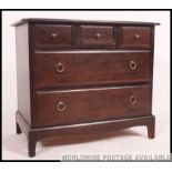 A Stag mahogany minstrel chest of drawer raised on shaped legs with a flared top above Measures: 72