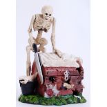 MONEY BOX: A 20th century cast iron hand painted style money box in the form of a macabre magician