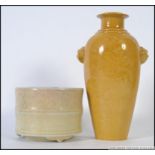 A Chinese monochrome yellow vase adorne