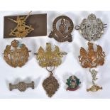 BADGES: A good collection of 10x assorted vintage military uniform badges to include a white metal