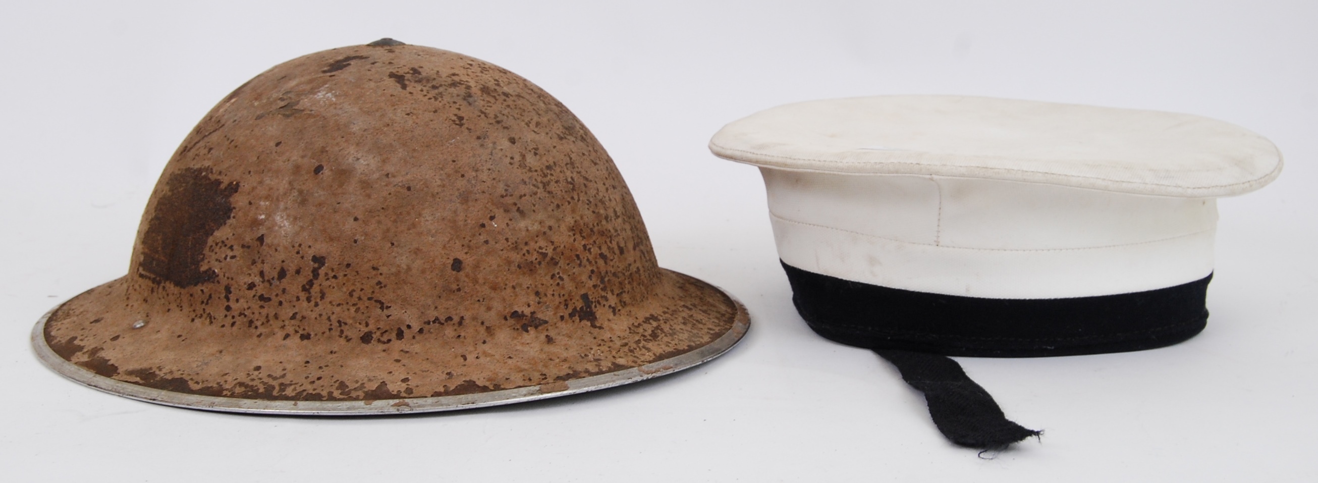 UNIFORM HATS: A vintage WWII Second World War tin helmet with original liner,