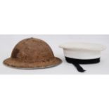 UNIFORM HATS: A vintage WWII Second World War tin helmet with original liner,