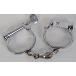 HANDCUFFS: An original pair of early 20th century Hiatt ' D ' policeman's handcuffs.