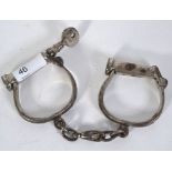 HANDCUFFS: An original pair of early 20th century Hiatt ' D ' policeman's handcuffs.