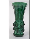 An unusual large Victorian green glass vase having trumpet form top on cylindrical body.