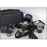 CAMERAS: Nikon 35 mm camera FG-20 plus a couple of lenses along with a 35 mm Pentax camera,