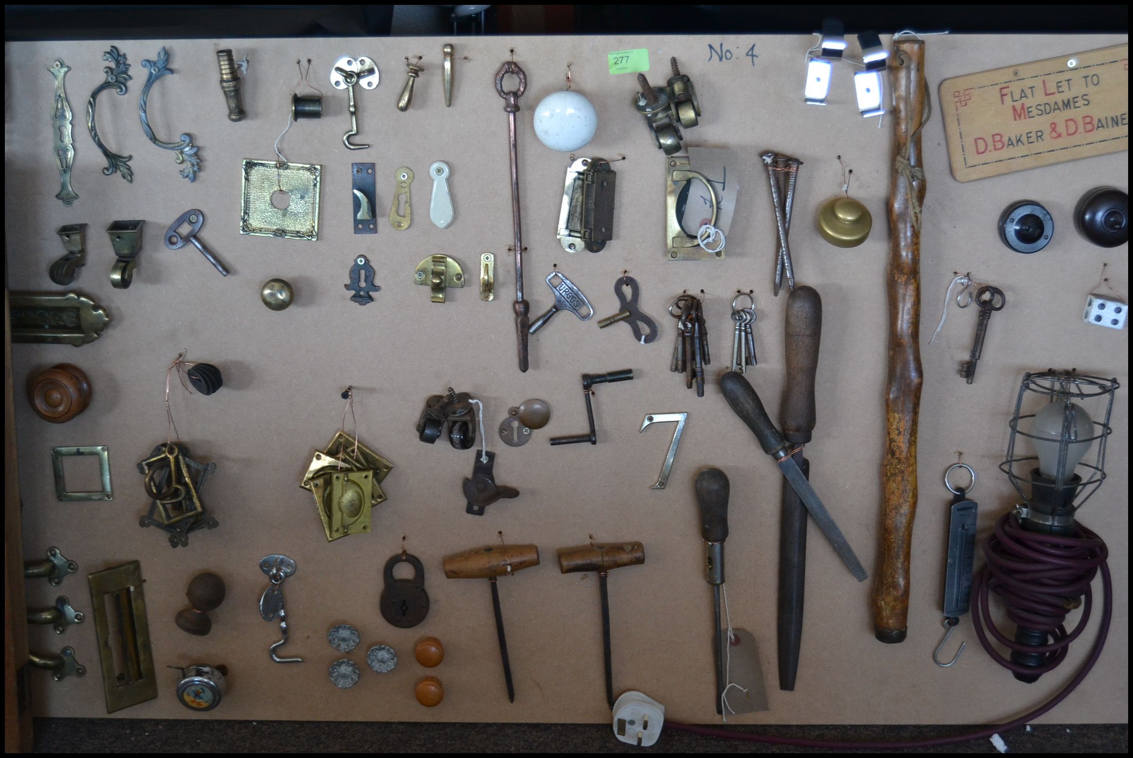 A fabulous collection of mounted handles, hinges, tools, doorknobs,