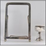 A silver hallmarked trophy / cup along with a silver plated easel picture frame Frame H18cm trophy