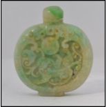 A Chinese green jade perfume bottle / moon flask with carved relief designs to the sides complete