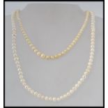 Two vintage cultured pearl necklaces, one with yellow metal spring hoop clasp,