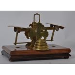 A pair of 19th century walnut and brass postal scales on cruciform supports complete with the