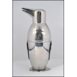 A silver plated novelty cocktail shaker in the form of a penguin having,