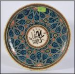 Azim Kutahya - a elaborately decorated hand painted Islamic art plate signed, Azim Kutahya to base,