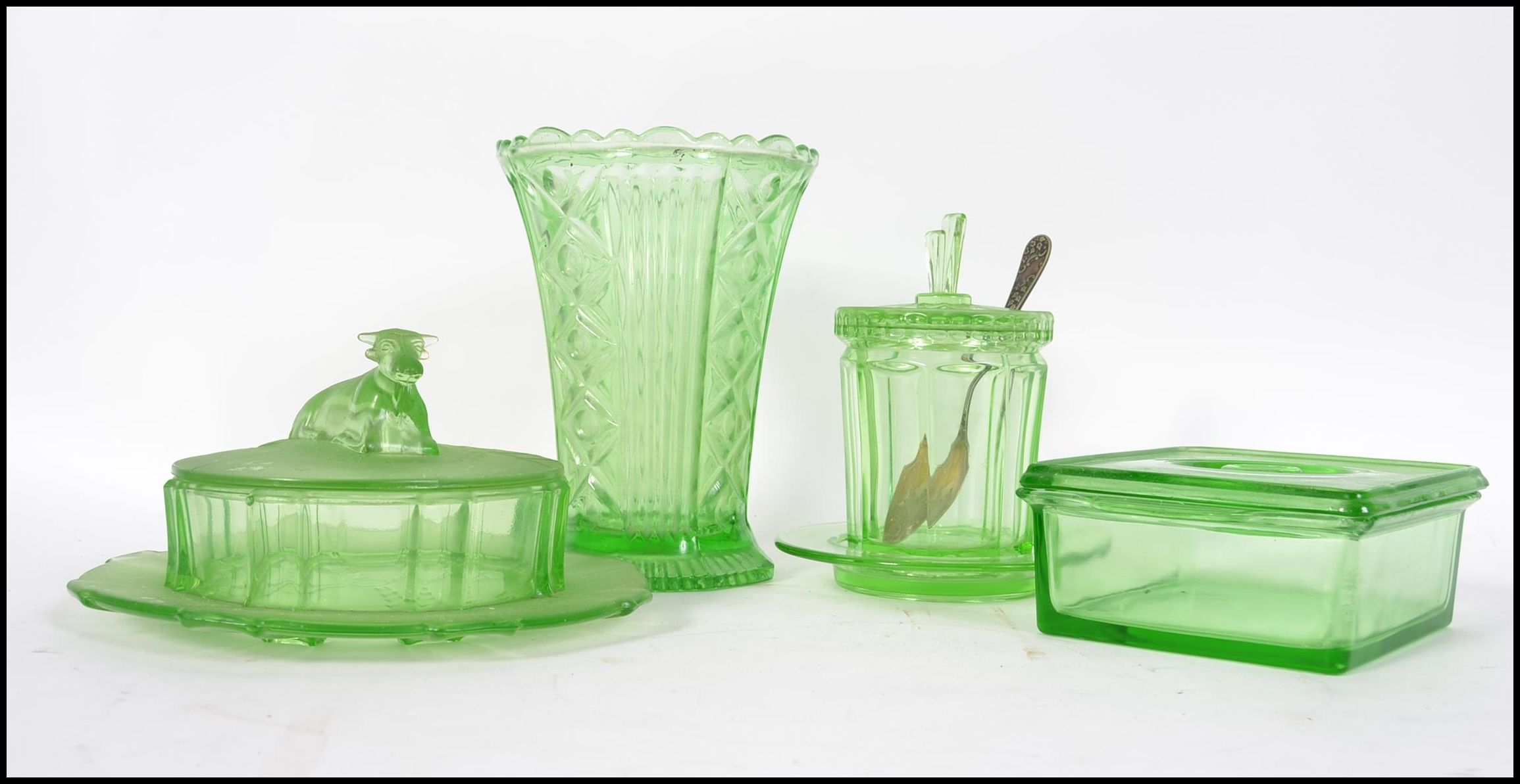 A collection of Art Deco early 20th century green glass / Vaseline pieces to include a stunning