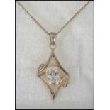 A gilded silver and cz pierced lozenge pendant and silver necklace complete in the presentation