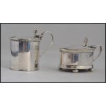 A near pair of silver hallmarked mustard pots with original liners,