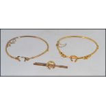 A pair of 9ct gold bracelets along with a matching 9ct gold brooch,