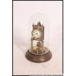 A 19th century Gustav Becker anniversary clock within glass dome and brass circular base.