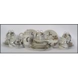 A Japanese translucent tea service with flowing dragon decoration, to include cups, saucers, teapot,