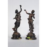 A pair of spelter male and female figures of Harvest with applied gilded finish representing