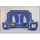 A group of three pieces of cobalt Wedgwood Jasperware having classical scenes to include a