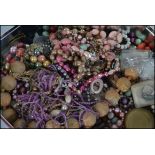 A collection of unsorted costume jewellery to include necklaces, bangles,