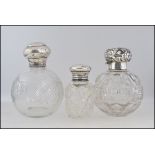 Three silver topped hallmarked cut glass perfume bottles,