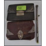 2 silver hallmarked embellished leather wallets together with an unusual silver rococo brush.