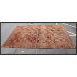 A large handwoven 20th century Turkish Kilim rug having red ground with central alternating