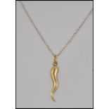 A 9ct gold pendant necklace with horn of plenty charm hallmarked Birmingham..