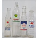 A collection of vintage mid century Industrial advertising automobilia glass oil bottles to include