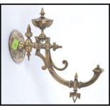 A Victorian / Edwardian early 20th century wall mountable metal spirit lamp bracket of unusual form.
