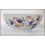 A 19th century Chinese bowl having hand painted floral design and with an early riveted repair.