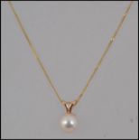 A 9ct gold pendant necklace with pearl pendant on a fine 9ct gold chain. Marked 375 Tests 9ct.