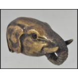 A 20th century brass vesta case in the form of an elephants head having hinged base and striker