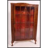 A good quality mahogany queen anne display cabinet raised on cabriole legs with shelved interior