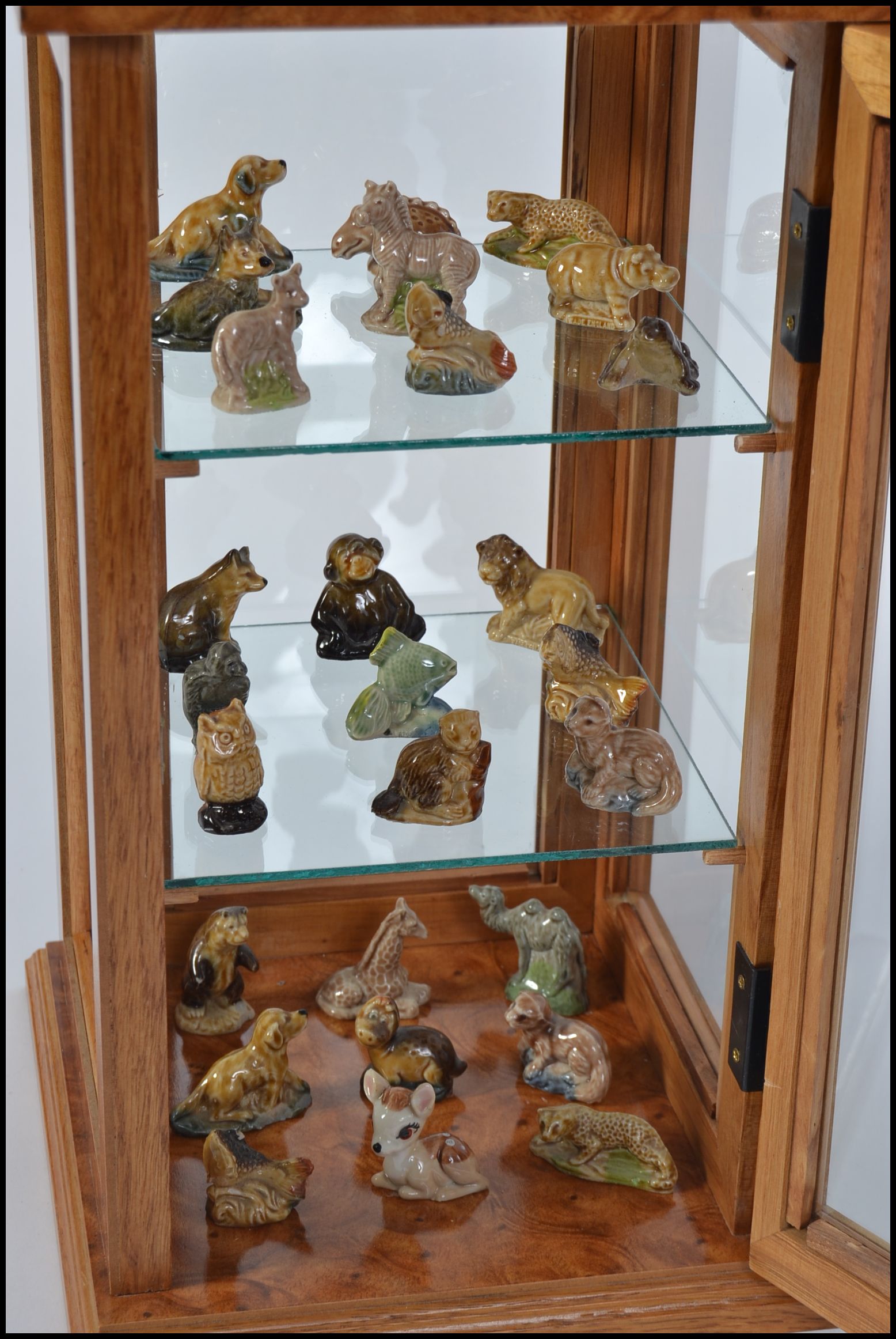 A collection of various ceramic Wade Whimsies complete with a small glazed upright display cabinet - Image 2 of 2