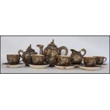 A late 19th /early 20th century Japanese Satsuma Signed Tea Service on black and gilt ground having