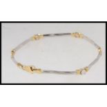 A 14ct gold and white gold ladies bracelet of twist bar link form complete with the clasp.