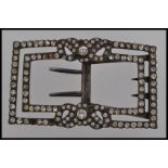 A large Victorian 19th century white metal buckle set with paste stones and floral motif with