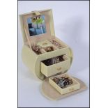 An Ostrich skin jewellery box containing a collection of costume jewellery such as necklaces,
