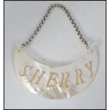 A contemporary mother of pearl ' sherry ' decanter label set to a white metal chain.