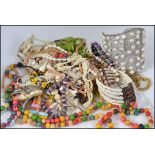 A collection of vintage costume jewellery to include beaded bracelets, necklaces etc,