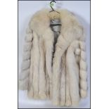 A ladies fox fur coat of a short length, likely around a size 18 and satin lined.