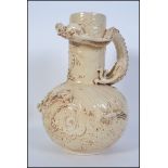 A late 19th century vase by Bretby having long neck with globular body in a pale brown glaze.