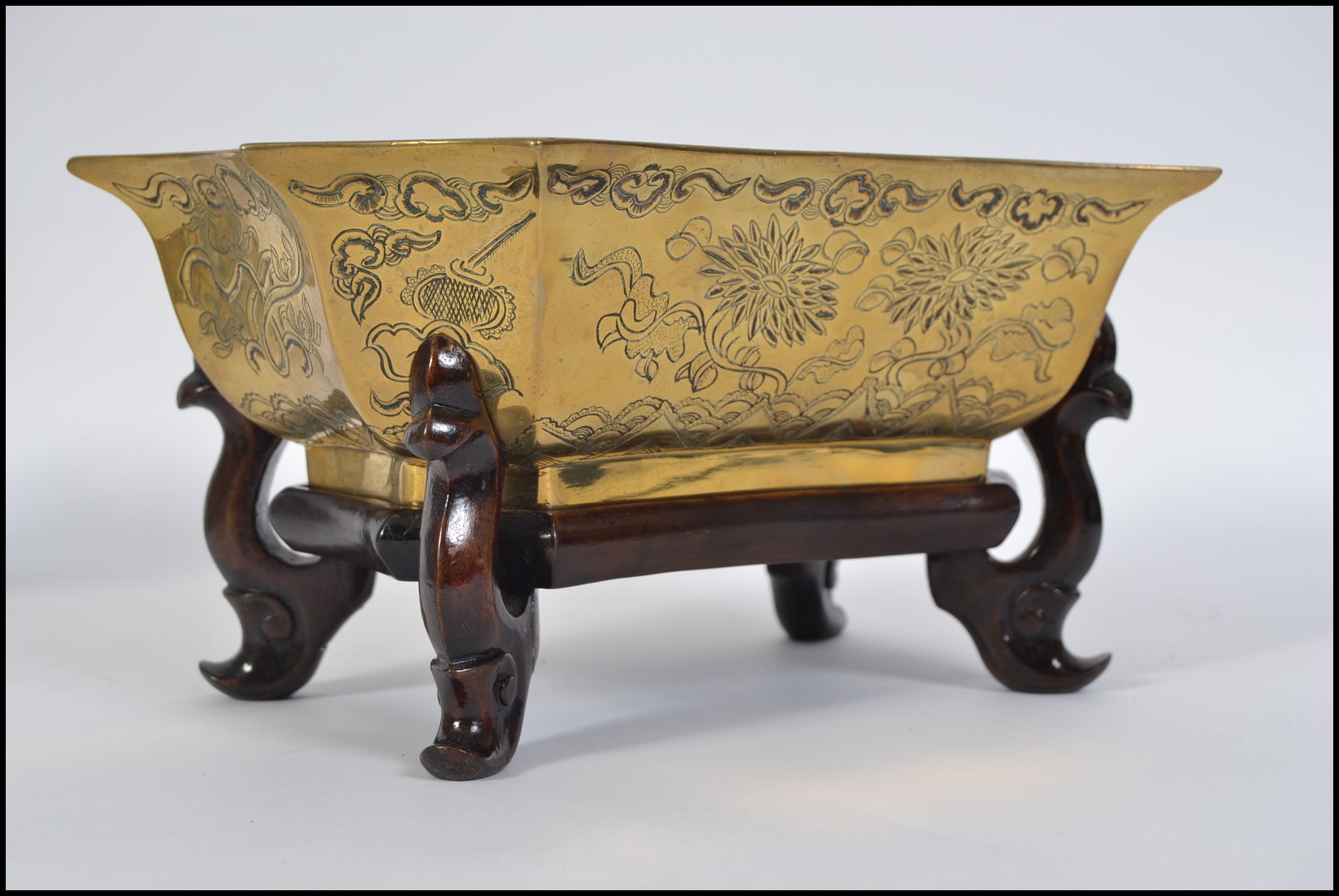 A good quality heavy brass bowl of Chinese origin having chase decorations of dragons and foliate