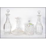 A pair of early 20th century cut glass decanters together with stoppers along with a ships decanter