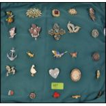 A collection of costume jewellery brooches all mounted onto a cushion,