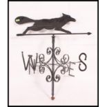 A large 20th century cast metal and ebonised weather vane with directional notation and fox above.