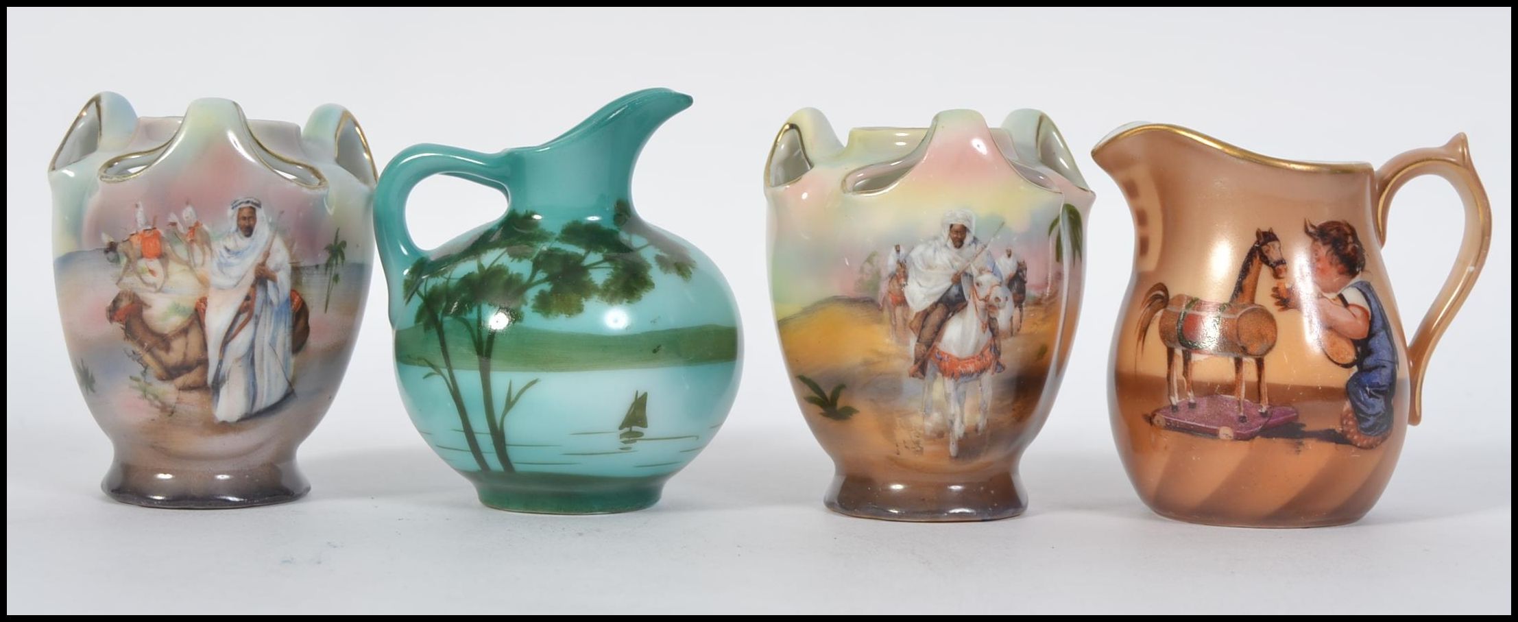 A collection of four small ceramic lustre jugs of Bavarian form,